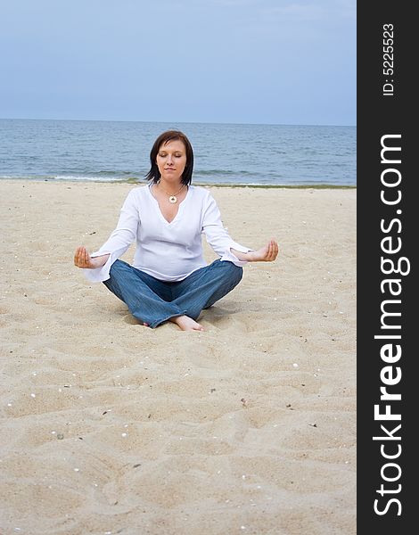 Pregnant woman sitting on beach. Pregnant woman sitting on beach