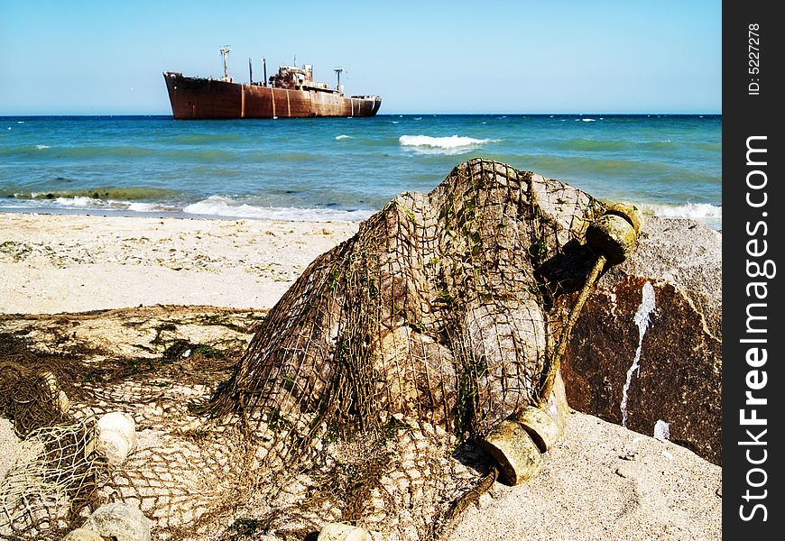 Ship wreck and fishing net on a rock