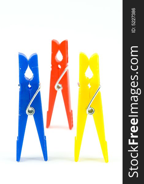 Coloured pegs on white background for hanging. Coloured pegs on white background for hanging