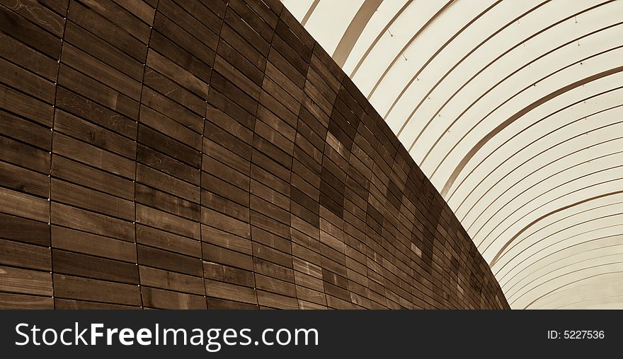 Abstract of metal arches and wooden tiled wall in the morning light. Abstract of metal arches and wooden tiled wall in the morning light