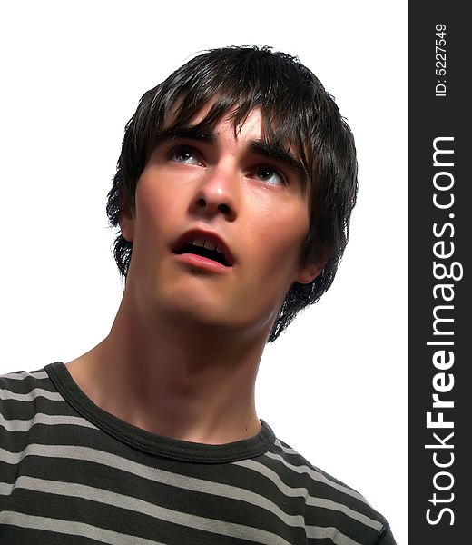 A portrait about a trendy cute young man who is looking up and he is surprised. He is wearing a striped t-shirt. A portrait about a trendy cute young man who is looking up and he is surprised. He is wearing a striped t-shirt.