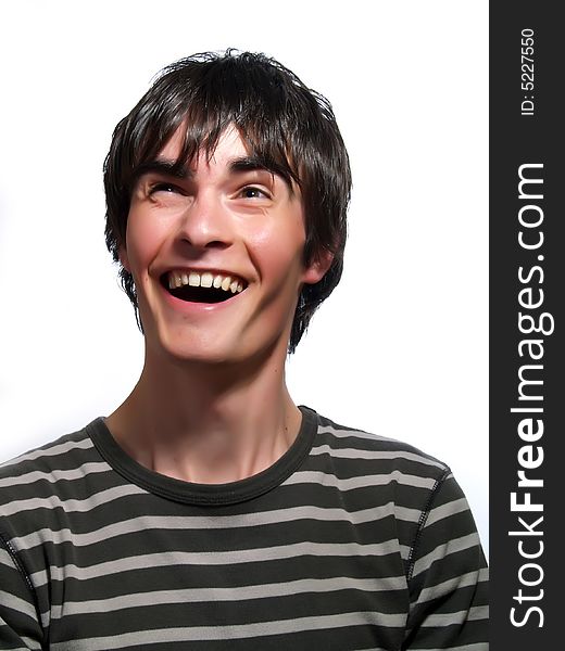 A portrait about a trendy attractive young guy who is looking up and he is laughing loud. He is wearing a striped t-shirt. A portrait about a trendy attractive young guy who is looking up and he is laughing loud. He is wearing a striped t-shirt.