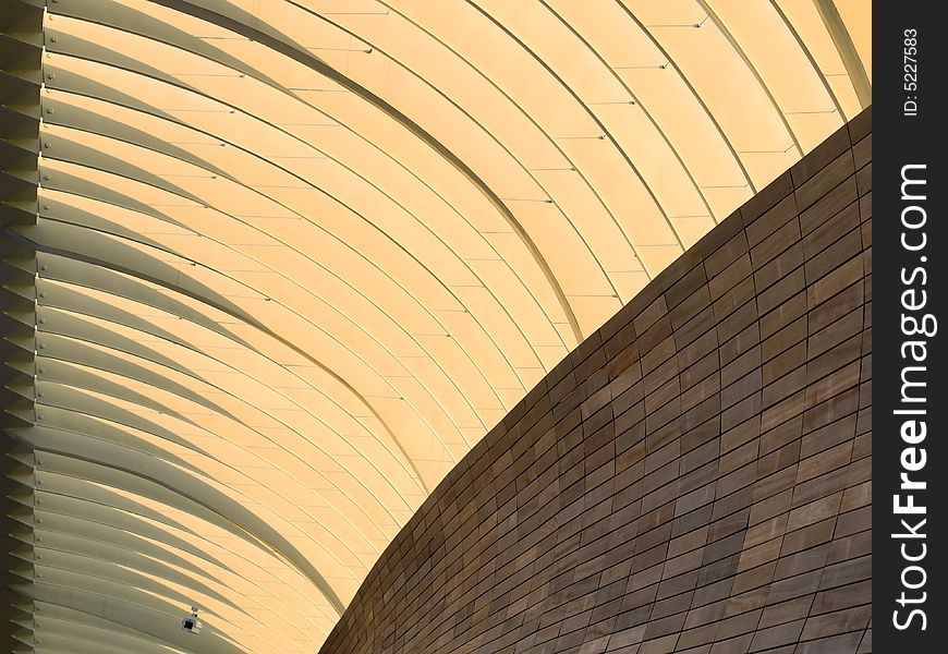 Abstract of metal arches and wood tiled wall in the morning light. Abstract of metal arches and wood tiled wall in the morning light