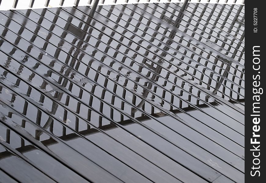 Railings reflected on the wet boardwalk after a tropical afternoon convectional shower. Railings reflected on the wet boardwalk after a tropical afternoon convectional shower