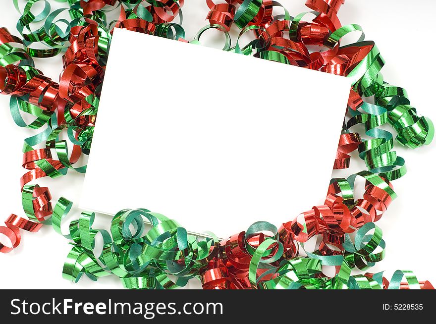 A blank note card surrounded by Christmas bows on a white background, great for gift tags etc,  with copy space. A blank note card surrounded by Christmas bows on a white background, great for gift tags etc,  with copy space