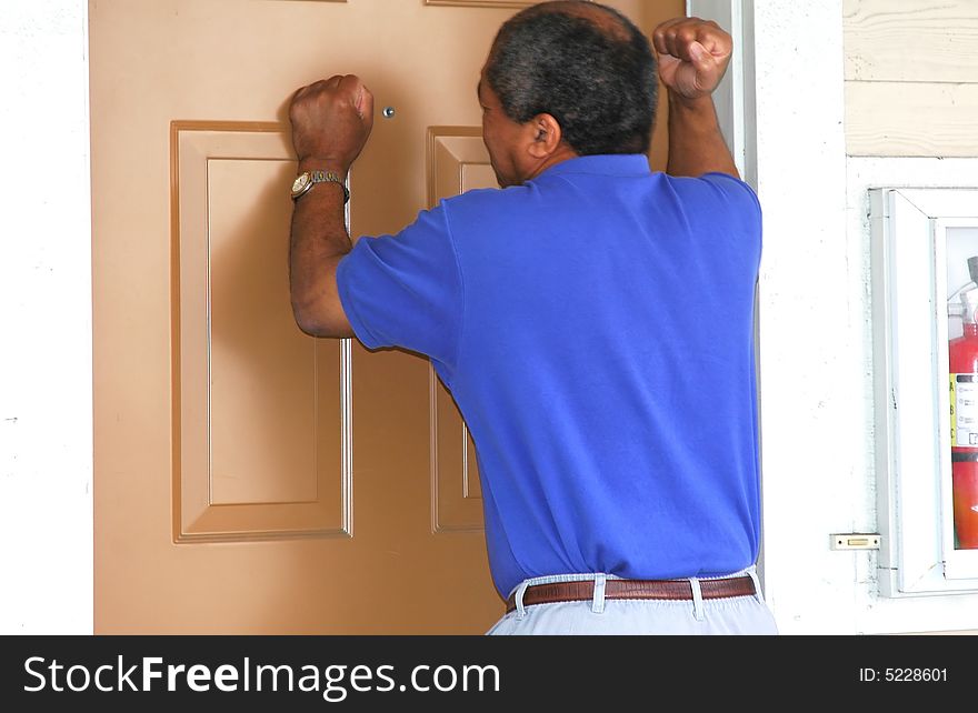 African american man breaking into a house in broad daylight. African american man breaking into a house in broad daylight.