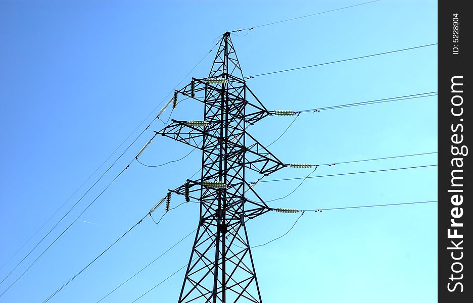 High volts power line on blue sky with insulators and wires. High volts power line on blue sky with insulators and wires