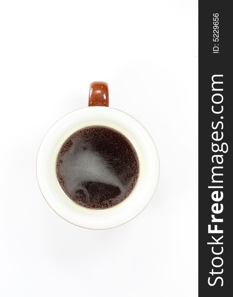 A cup of espresso on white background seen from top. A cup of espresso on white background seen from top