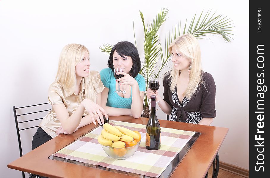 Three girlfriends drinking wine and having fun