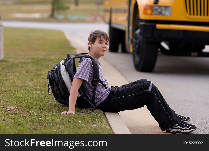 Student at school bus stop. Student at school bus stop