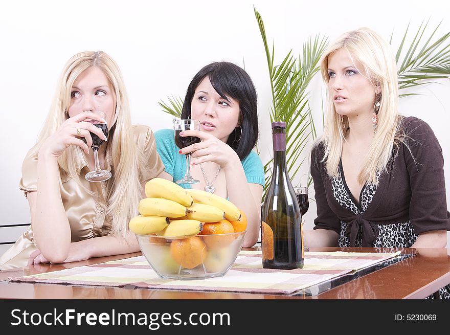 Three girlfriends drinking wine and having fun