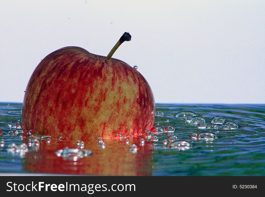 Fresh apple in the bubbling water, a fresh and healthy dessert in the summer