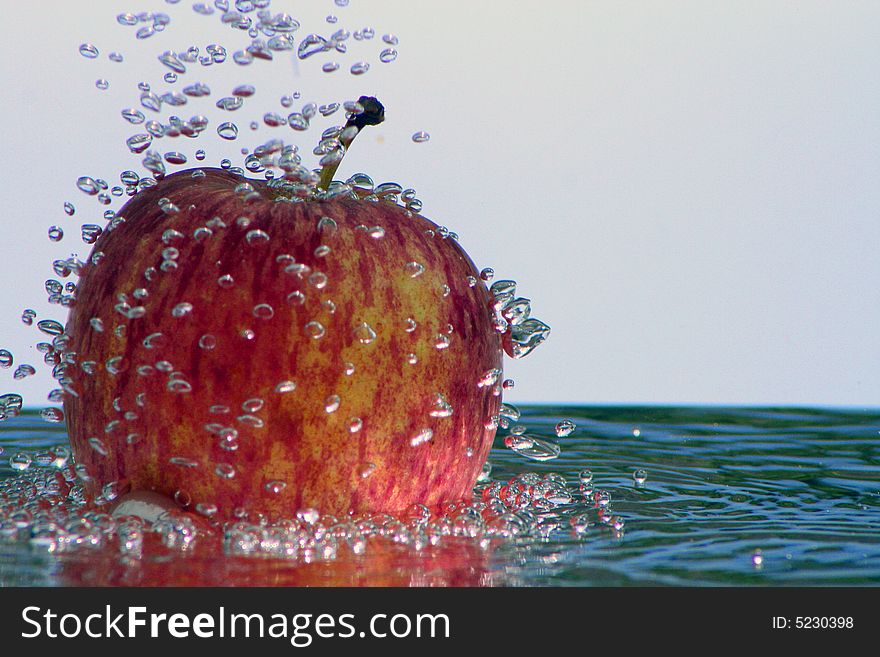 Fresh apple in the bubbling water, a fresh and healthy dessert in the summer