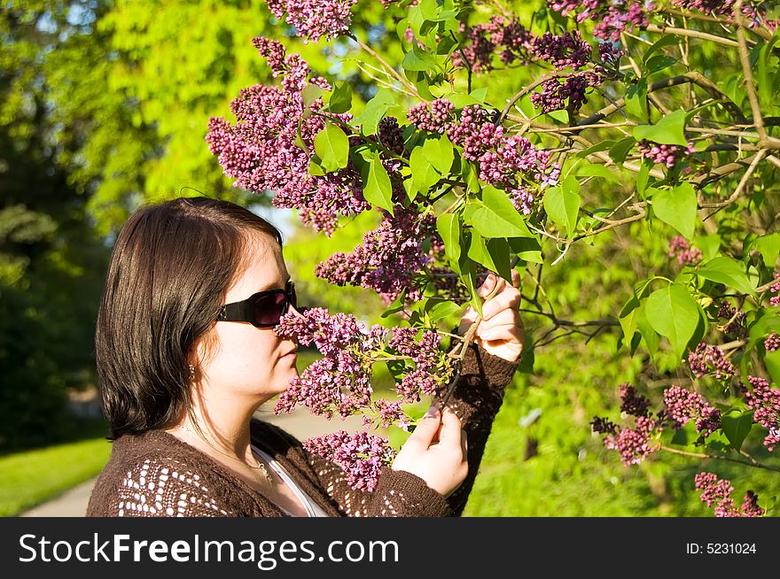 Woman is sensing flavour of flower in the park