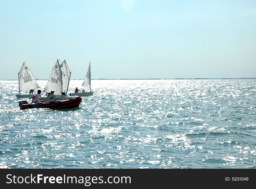 Young people sailing under clear sky. Young people sailing under clear sky