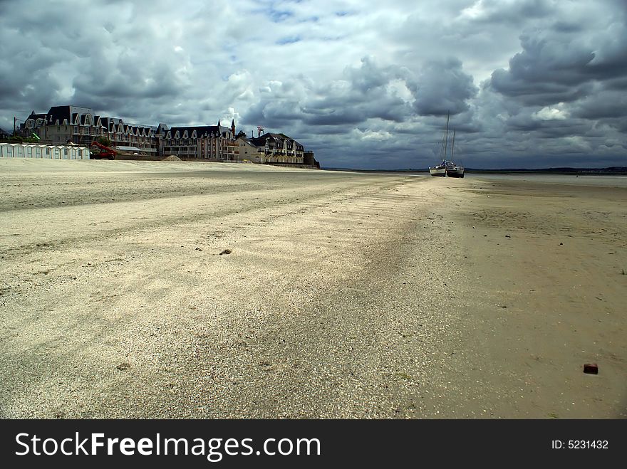 An Empty beach in France with a cloudy sky