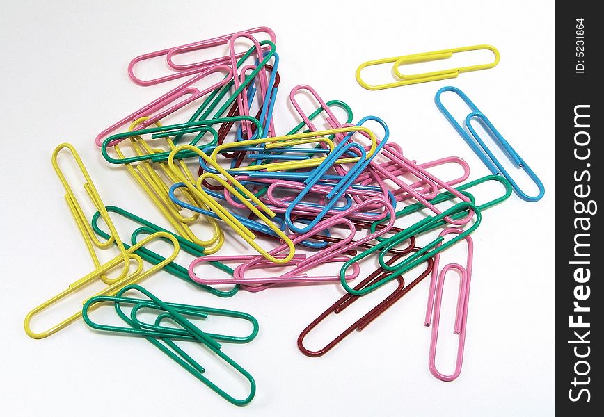 Assorted colored paper clips on a white background. Assorted colored paper clips on a white background