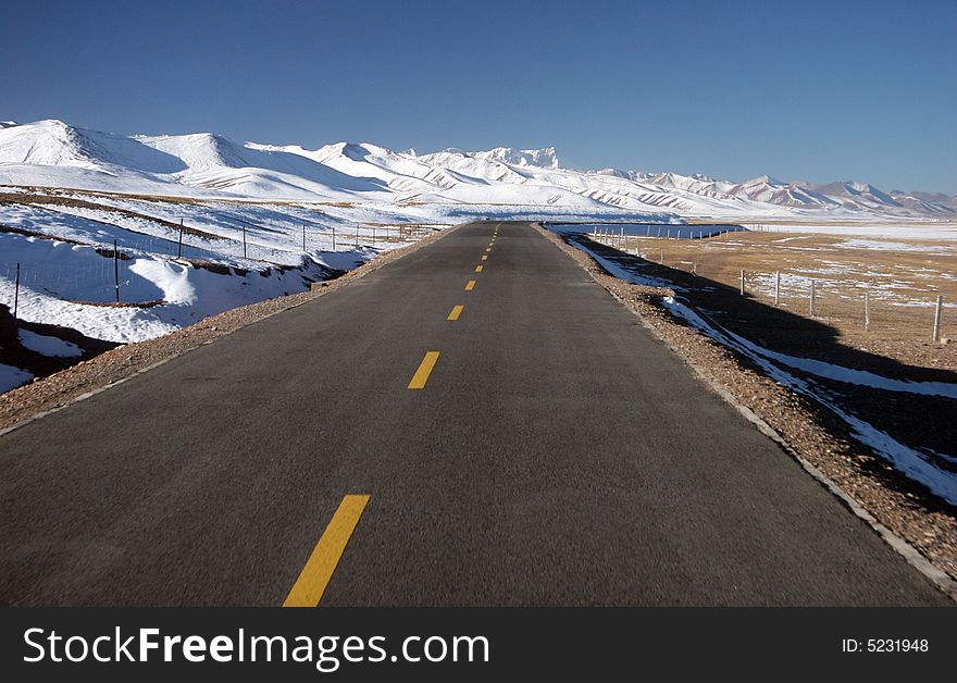 High mountain pass with a scenic road and snowcapped mountains. Tibet