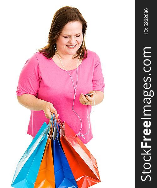 Pretty plus-sized woman holding her shopping bags and listening to music.  Isolated on white. Pretty plus-sized woman holding her shopping bags and listening to music.  Isolated on white.