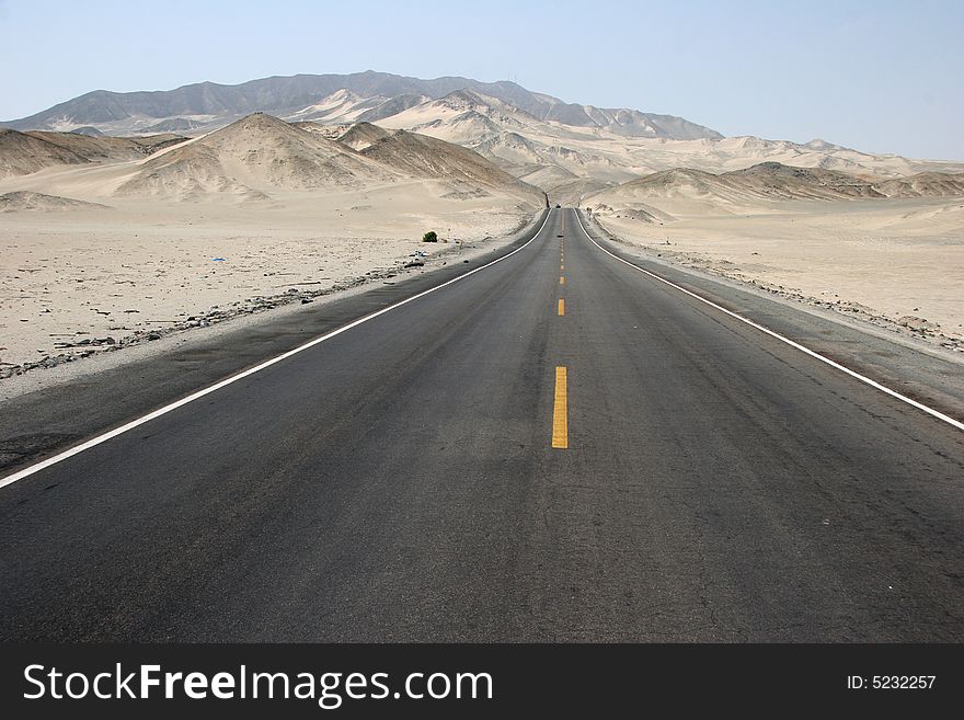 Typical Peruvian road with sand rolling landscape. Peru