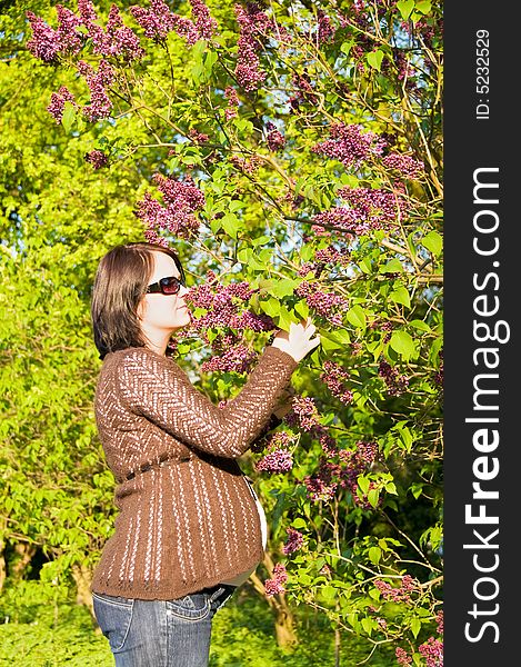 Pregnant woman sensing flavour in the park. Pregnant woman sensing flavour in the park