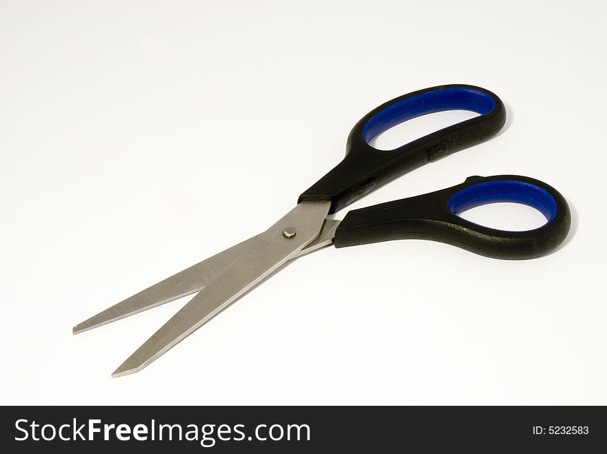 Scissors with plastic blue handles placed over white background