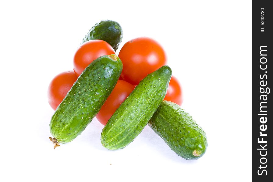 Tomatoes and cucumbers isolated on a white background. Tomatoes and cucumbers isolated on a white background