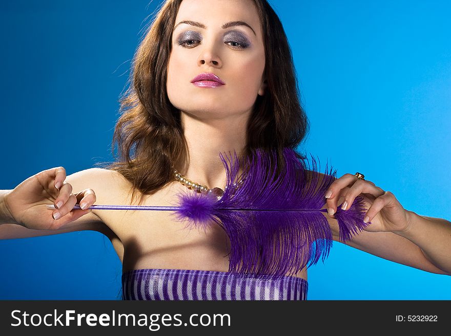 Young woman with feather on hands