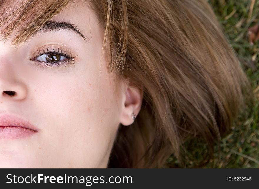 Beautiful lying woman in green grass