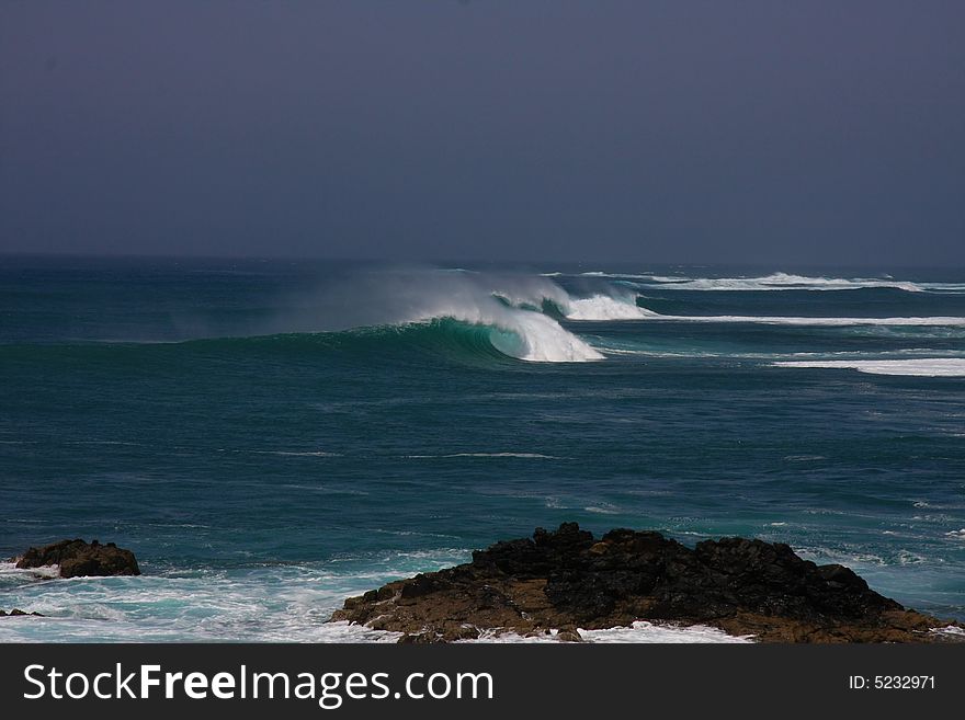 Huge wave breaking in off shore wind. Huge wave breaking in off shore wind