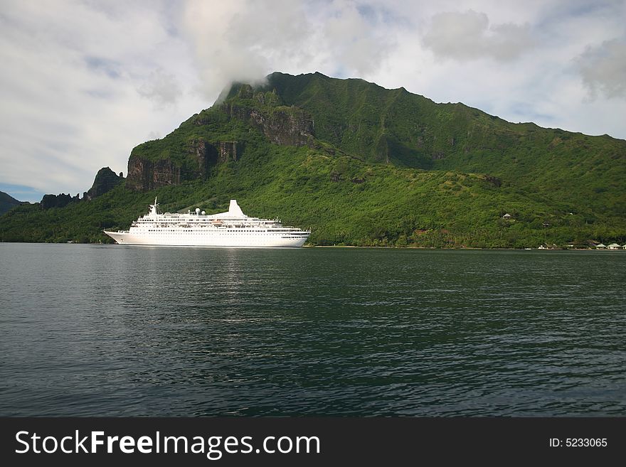 Modern cruise ship approaching port on Island Moorea. French Polynesia