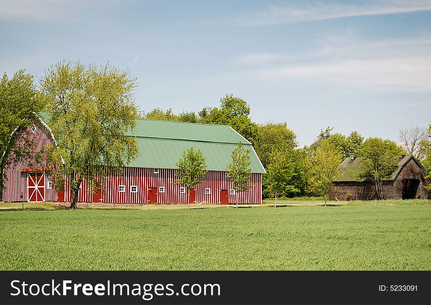 New red barn next to the old one. New red barn next to the old one.