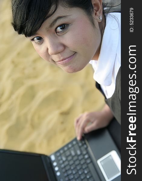 Asian business woman on the beach sand