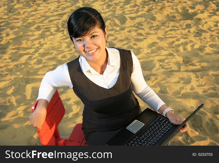 Sweet girl working on laptop at beach sand. Sweet girl working on laptop at beach sand