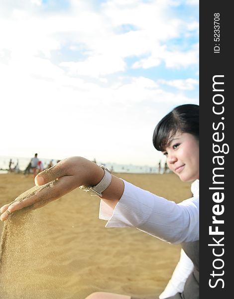 Business woman holding and enjoy beach sand. Business woman holding and enjoy beach sand