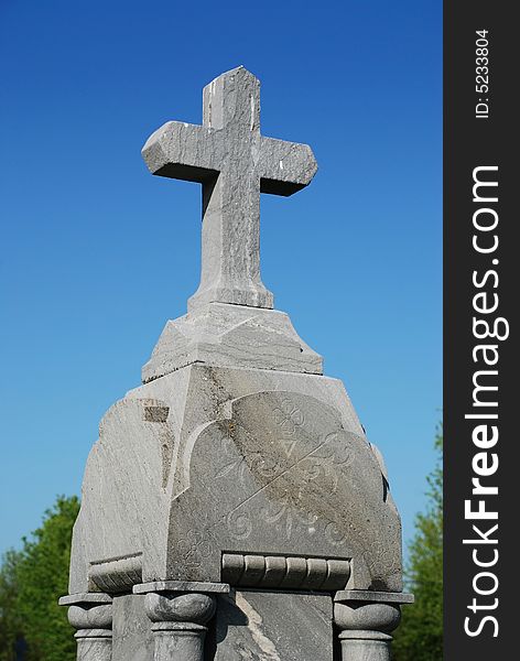 Cross of granit on old memorial monument