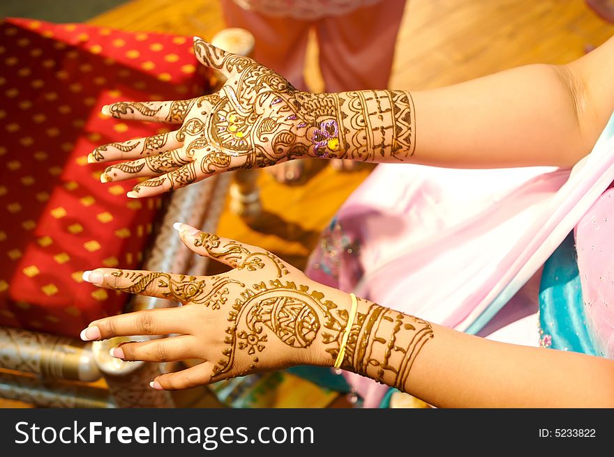 Indian wedding bride getting henna applied