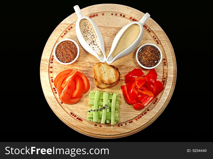 Sauce, tomato and pepper on a wooden support