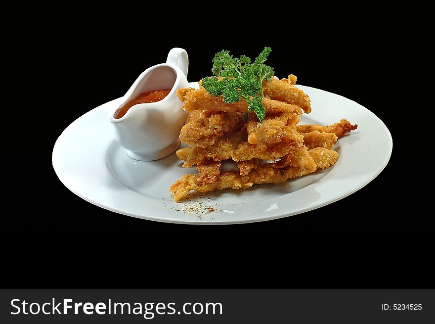 Meat with a potato and sauce on a dish on a black  background