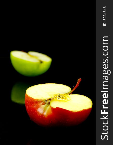 Apple halves isolated against a black background. Apple halves isolated against a black background