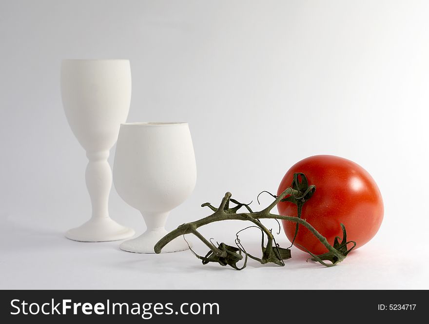 The White glasses and red tomato