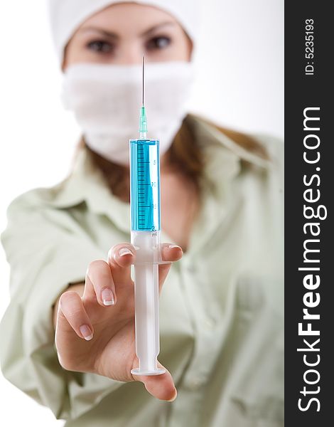 An image of nurse in a mask with an injection. An image of nurse in a mask with an injection