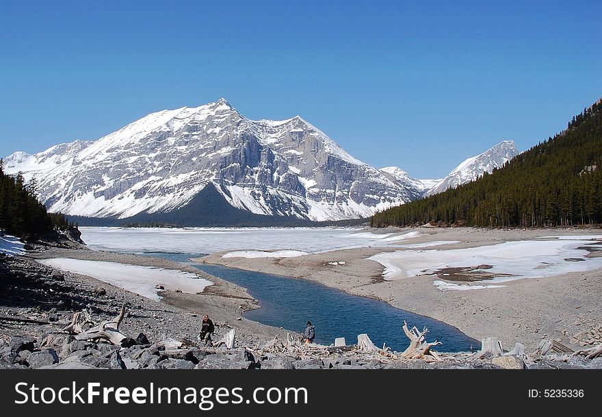 Spring view of alpine lake and surrounding mountains, kananaskis, alberta, canada. Spring view of alpine lake and surrounding mountains, kananaskis, alberta, canada