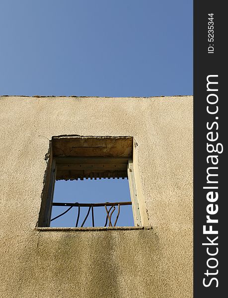 An old wall with a frame window. An old wall with a frame window