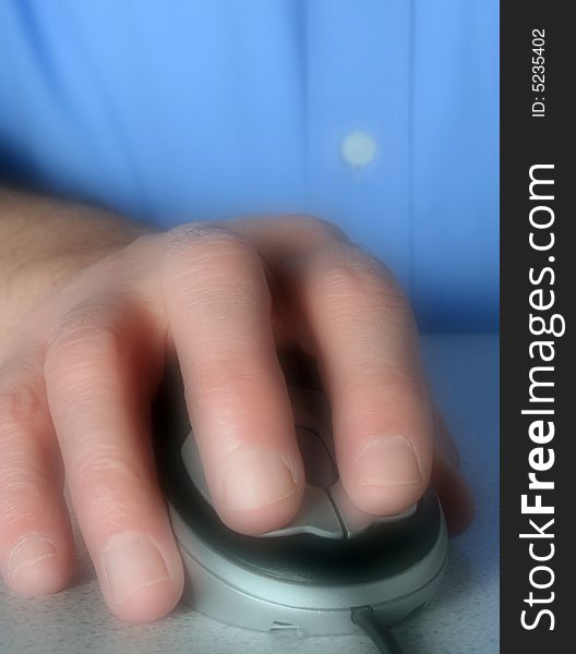 Soft focus applied to man using computer mouse. Soft focus applied to man using computer mouse