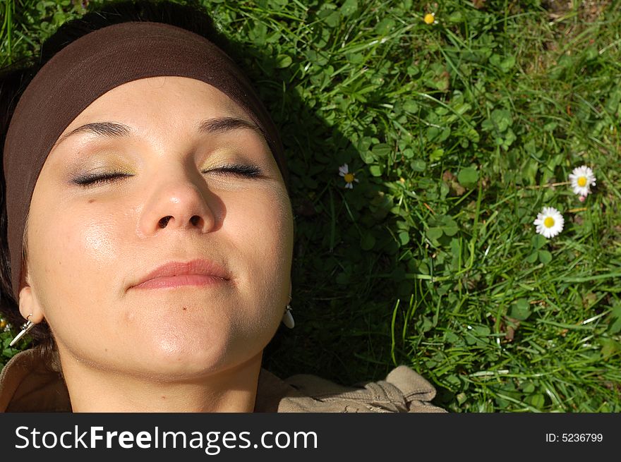 Attractive woman relaxing on green grass. Attractive woman relaxing on green grass
