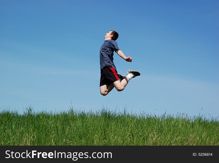 Happy jumping kid on sky background