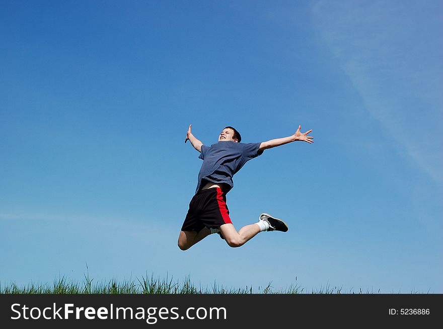 Happy jumping kid on sky background