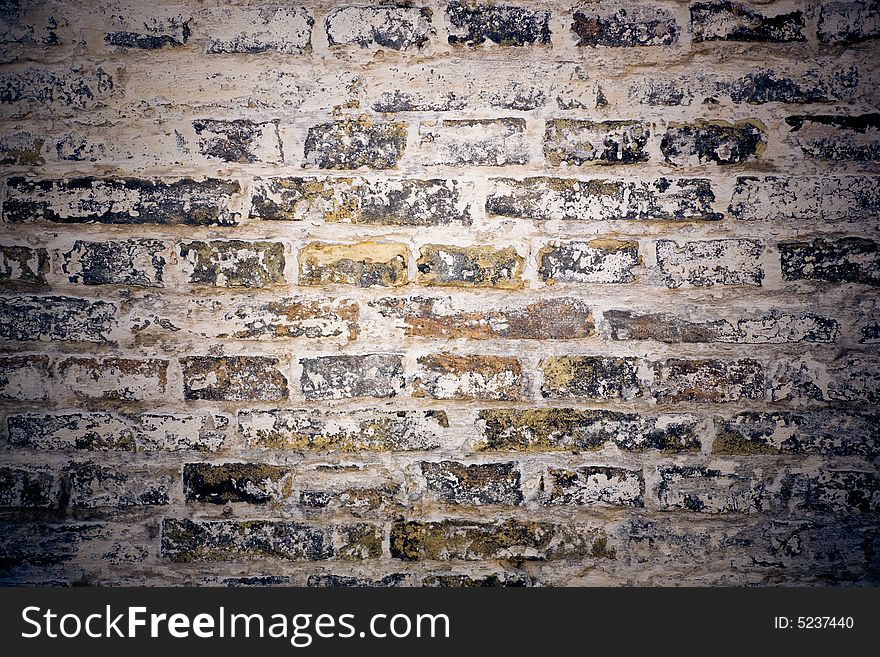 Old grungy wall of mixed bricks in cold tones ,chalk is comming off