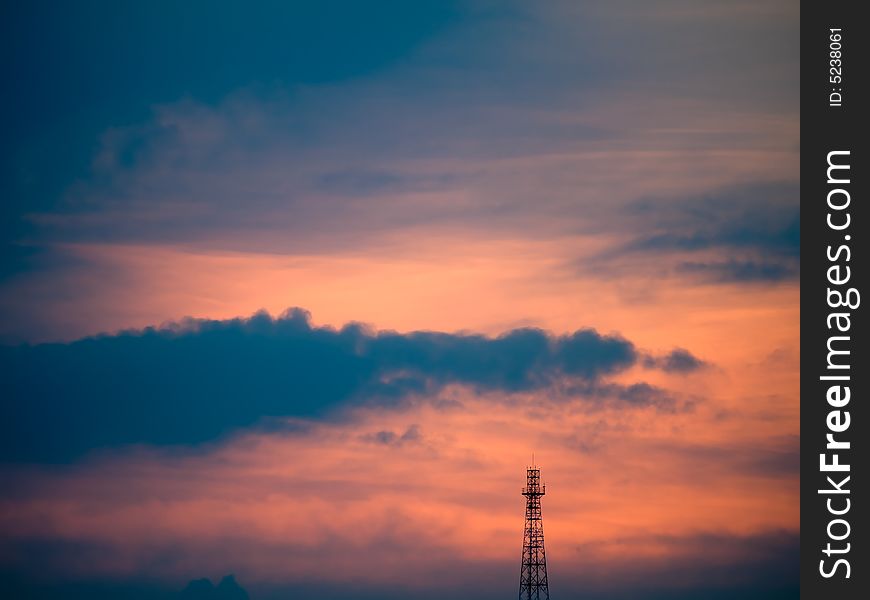 Antenna Tower silhouetted against an overcast sky at sunset. Antenna Tower silhouetted against an overcast sky at sunset